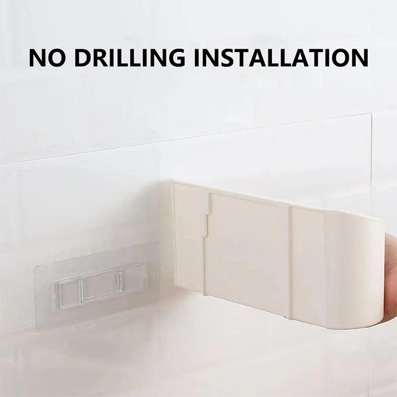 The back of the storage caddy next to its clear adhesive mounting pad on a tiled wall, captioned no drilling installation.