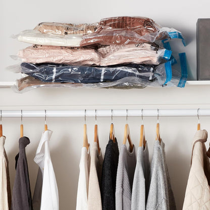 Compressed bags stacked flat in the top of a wardrobe