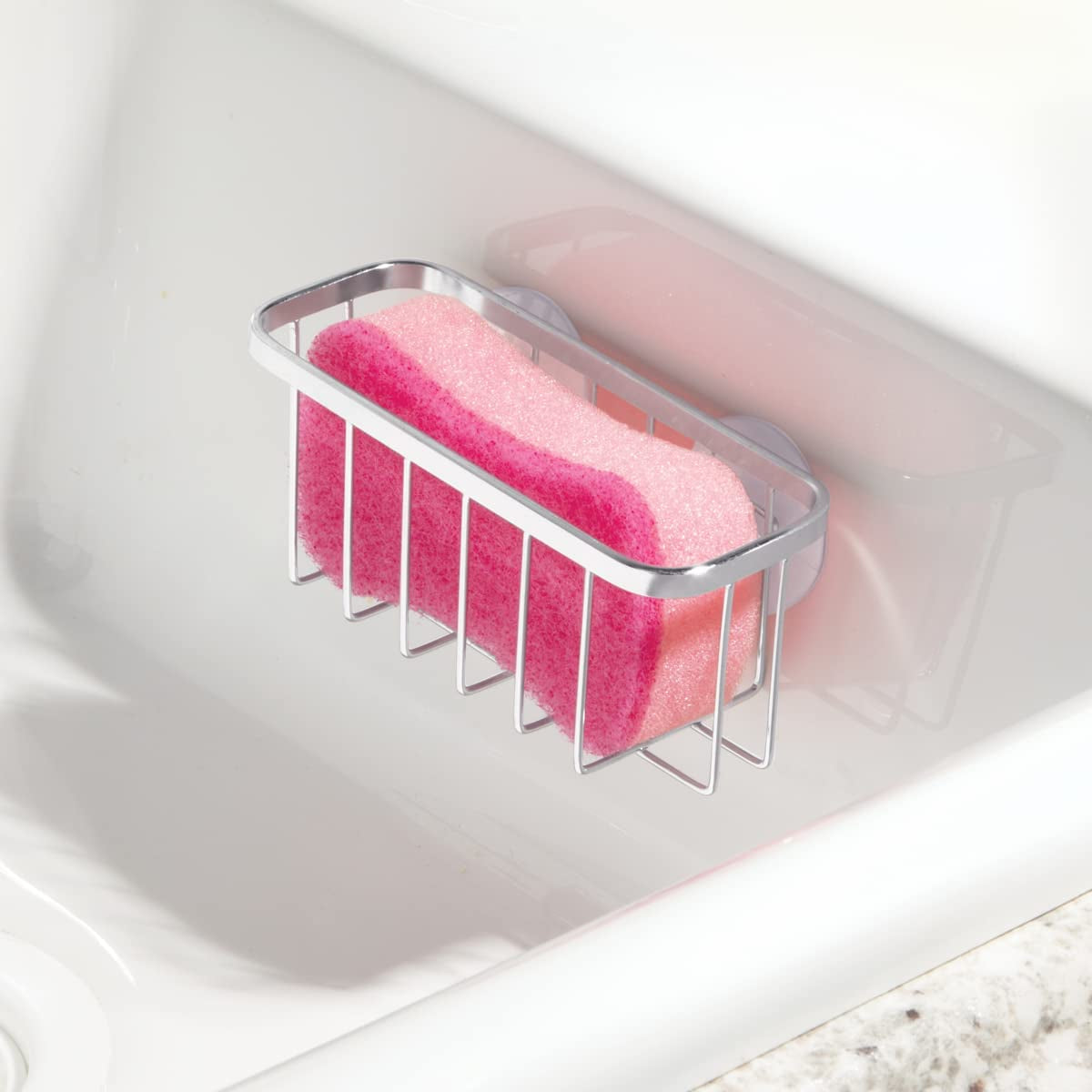 The holder with a sponge in it, draining clear of the worktop