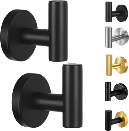Two matte black towel hooks mounted on a bathroom wall