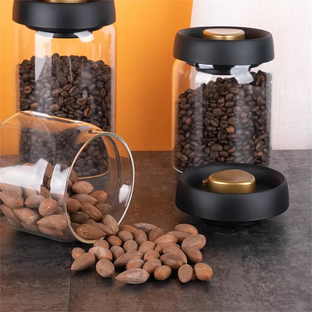Two vacuum coffee canisters upright and one on its side with nuts spilling out, showing the jar can hold more than coffee.